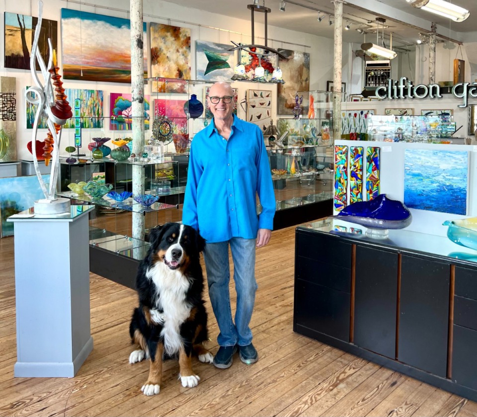 <strong>Artist and gallery owner Tom Clifton and Mylo, T Clifton Art&rsquo;s fifth gallery pup.</strong> (Courtesy Tom Clifton)