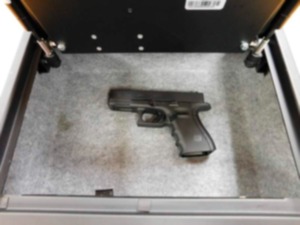 This undated photo shows a Glock 19 handgun in a safe at the Jay County School Corp. administration building. Jeremy Gulley, Superintendent of Jay County School Corp, would not say whether he would be among the administrators, faculty or staff allowed to retrieve the loaded Glock 19 handgun in the event of an attack on a school building &mdash; although he did produce a locked, Glock-storing safe during an interview at the administration building in September. (Brian Francisco/The Journal-Gazette via AP)