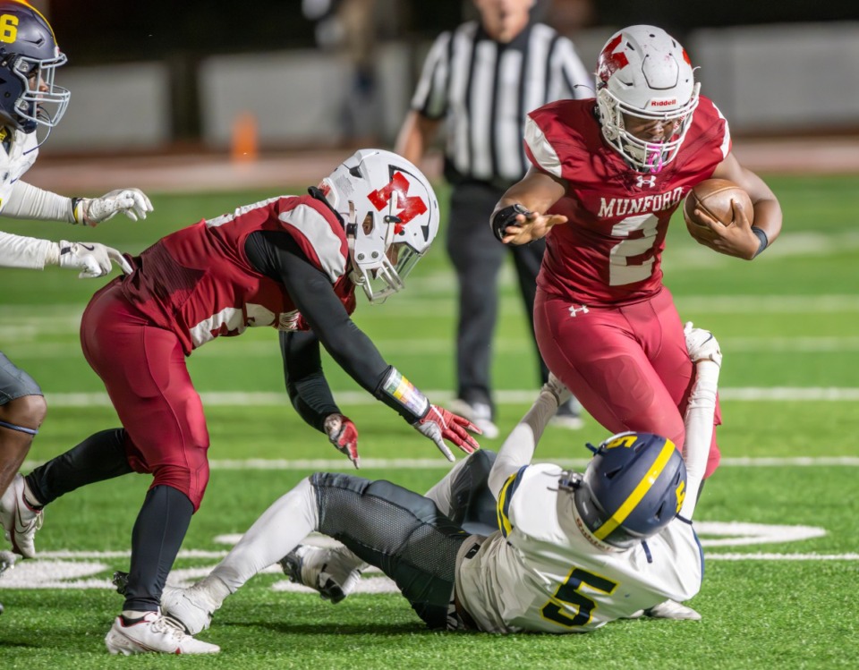 <strong>Munford&rsquo;s Tay Starks (2) is stopped by Lausanne's Kaleb White (5) on Friday, Oct. 18, 2024.</strong>&nbsp;<strong>Starks ended up scoring four touchdowns.&nbsp;</strong>(Greg Campbell/Special to The Daily Memphian)