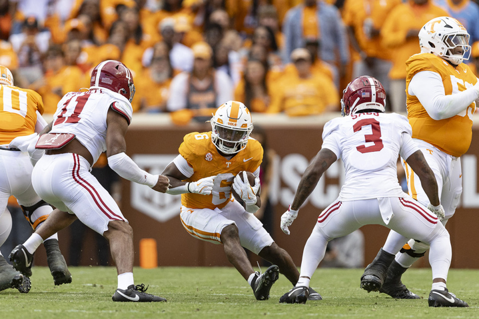 <strong>Tennessee running back Dylan Sampson (6) runs for yardage as he's chased by Alabama linebacker Jihaad Campbell (11) and defensive back Keon Sabb (3) during the first half of an NCAA college football game Saturday, Oct. 19, 2024, in Knoxville.</strong> (Wade Payne/AP Photo file)