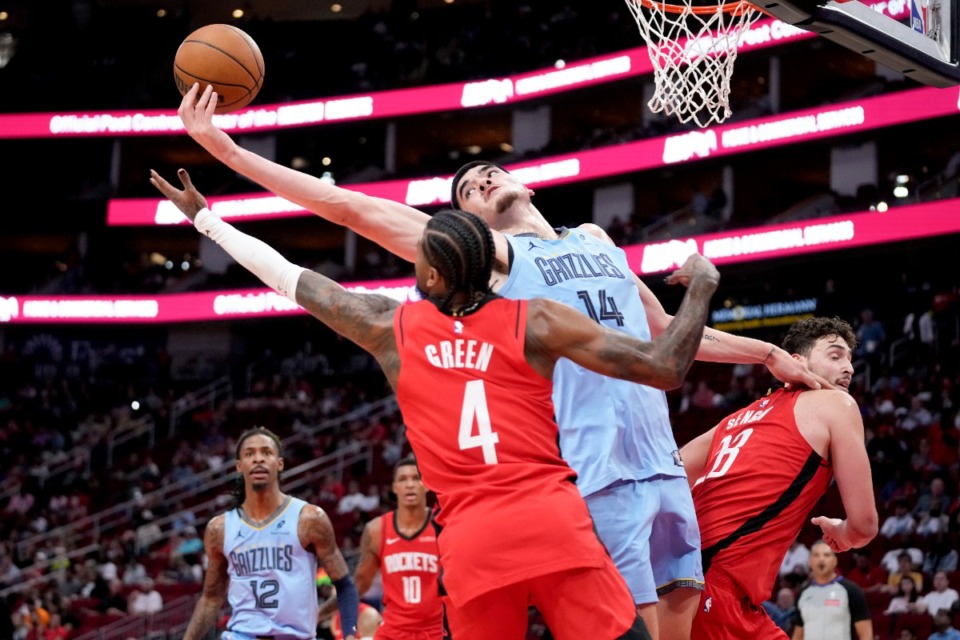 <strong>Memphis Grizzlies center Zach Edey (14) reaches for a rebound over Houston Rockets guard Jalen Green (4) on Friday, Oct. 25, 2024, in Houston.</strong> (Eric Christian Smith/AP)