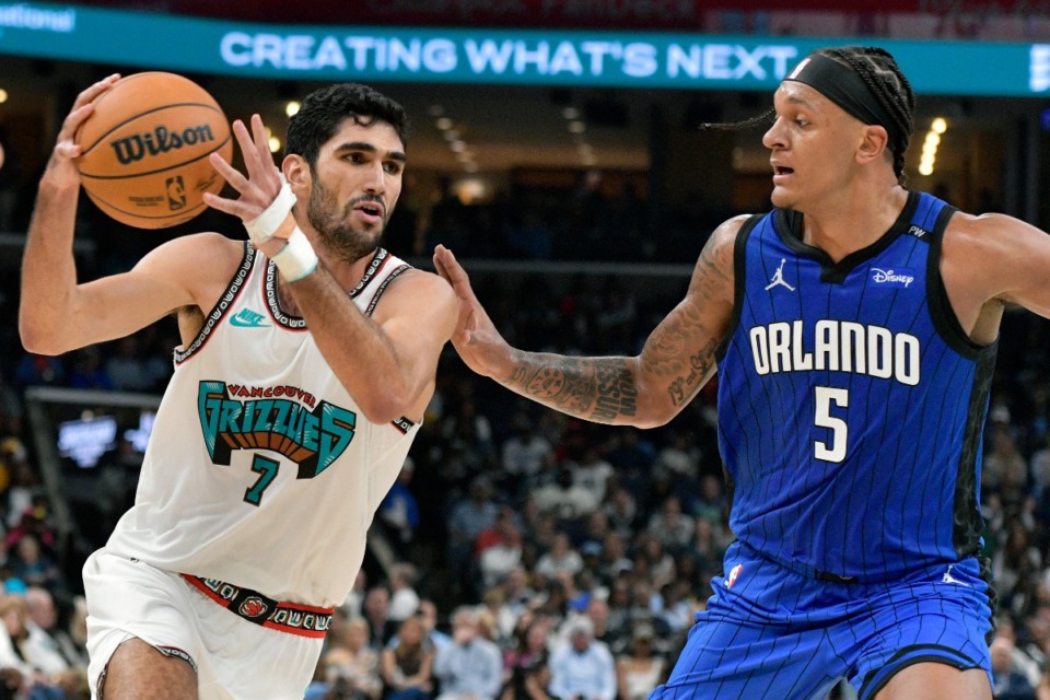 <strong>Memphis Grizzlies forward Santi Aldama (7) drives against Orlando Magic forward Paolo Banchero (5) in the NBA basketball game at FedExForum.</strong> (Brandon Dill/AP)