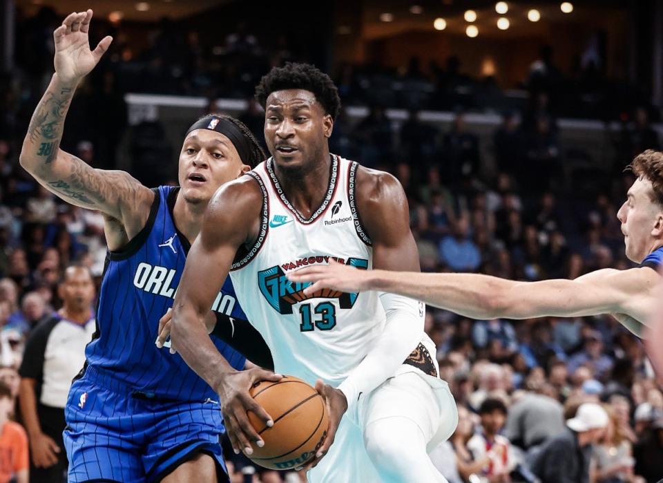 <strong>Wearing a classic Vancouver Grizzlies uniform to mark the franchise&rsquo;s 30th anniversary,&nbsp; forward Jaren Jackson Jr. drives the lane against Orlando Magic defender Paolo Banchero.&nbsp;&ldquo;They are the best uniforms in sports,&rdquo; Jackson said.</strong> (Mark Weber/The Daily Memphian)