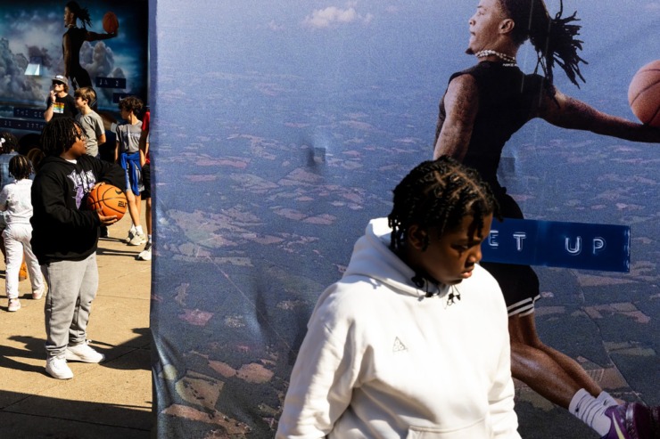 <strong>Visitors shoot hoops in front of a Ja Morant poster during the community block party Sunday, Oct. 27 at Snowden School.</strong> (Brad Vest/Special to The Daily Memphian)