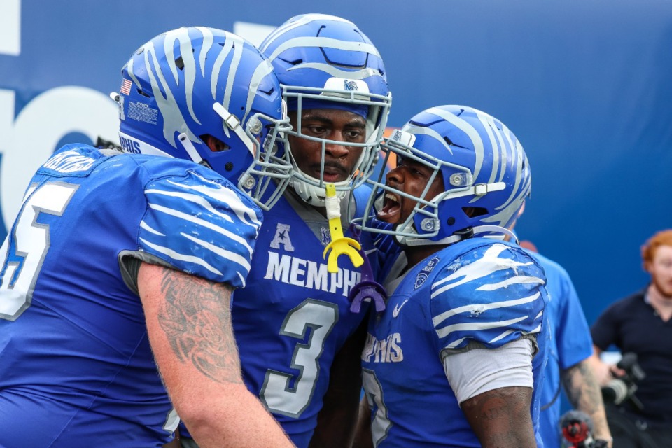 <strong>Memphis Tiger offensive lineman Jonah Gambill (65), Memphis Tiger wide receiver Roc Taylor (3) and Memphis Tiger running back Mario Anderson (2) celebrate after a touchdown during the fourth quarter against Charlotte on Oct. 26 at Simmons Bank Liberty Stadium.</strong> (Wes Hale/Special to The Daily Memphian)