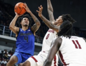 <strong>University of Memphis guard P.J. Haggerty (left) drives to the basket against the University of Alabama on Monday, Oct. 28, 2024.</strong> (Mark Weber/The Daily Memphian)