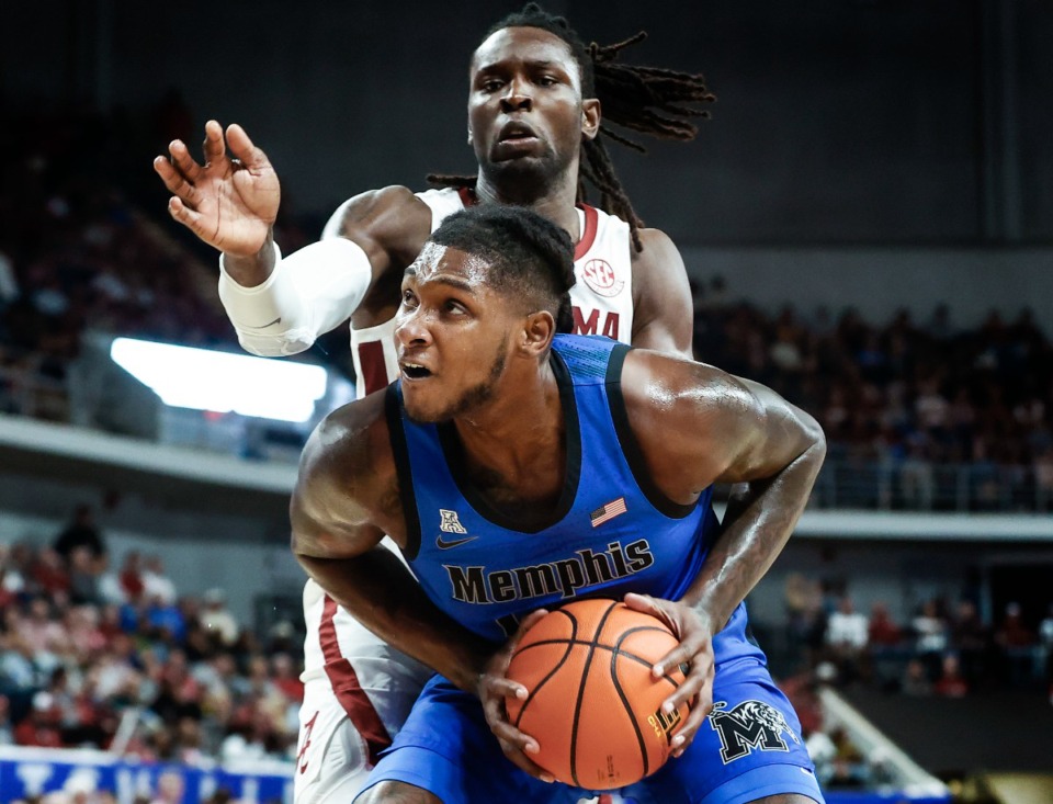 <strong>University of Memphis center Dain Dainja (front) drives the lane against University of Alabama defender Clifford Omoruyi (back) during action on Monday, Oct. 28, 2024.</strong> (Mark Weber/The Daily Memphian)