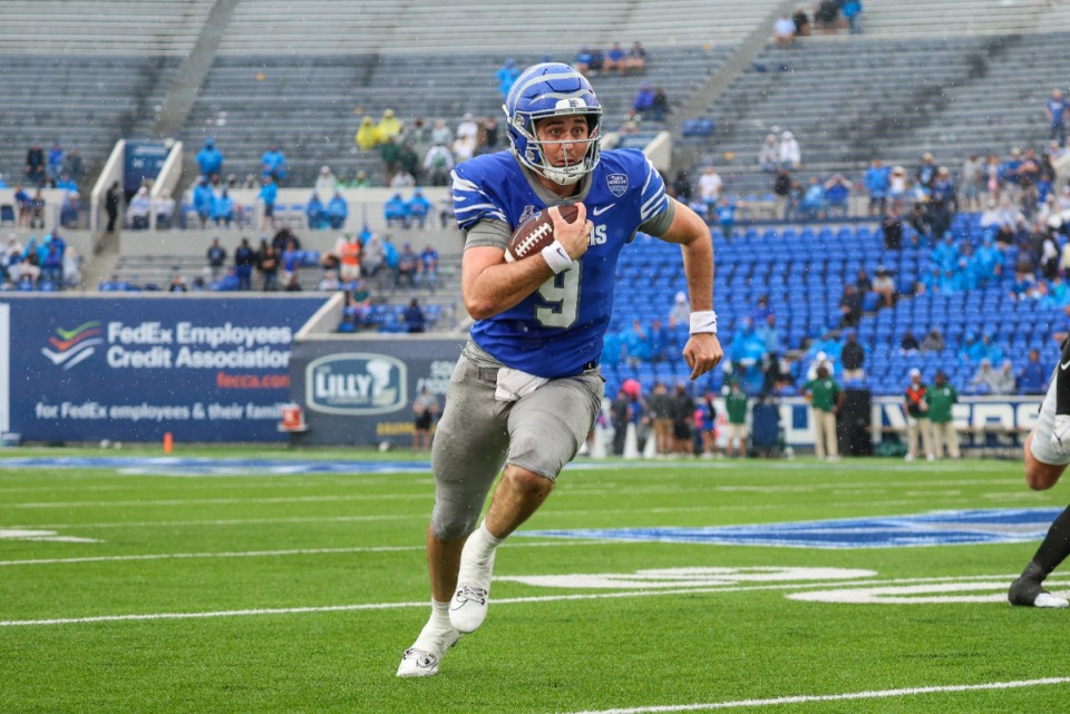 <strong>Memphis Tiger quarterback Seth Henigan, 9, runs with the ball during the third quarter against Charlotte Oct 26 at Simmons Bank Liberty Stadium.</strong> (Wes Hale/Special to The Daily Memphian)