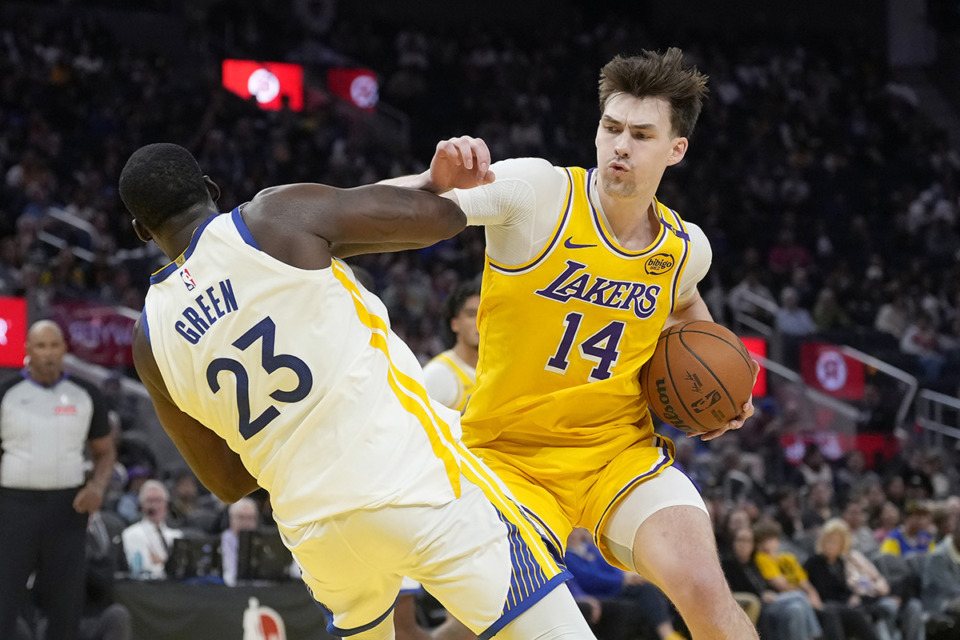 <strong>Los Angeles Lakers center Colin Castleton (14) drives to the basket against Golden State Warriors forward Draymond Green (23) during the first half of an NBA preseason basketball game in San Francisco, Friday, Oct. 18, 2024.</strong> (Jeff Chiu/AP file)