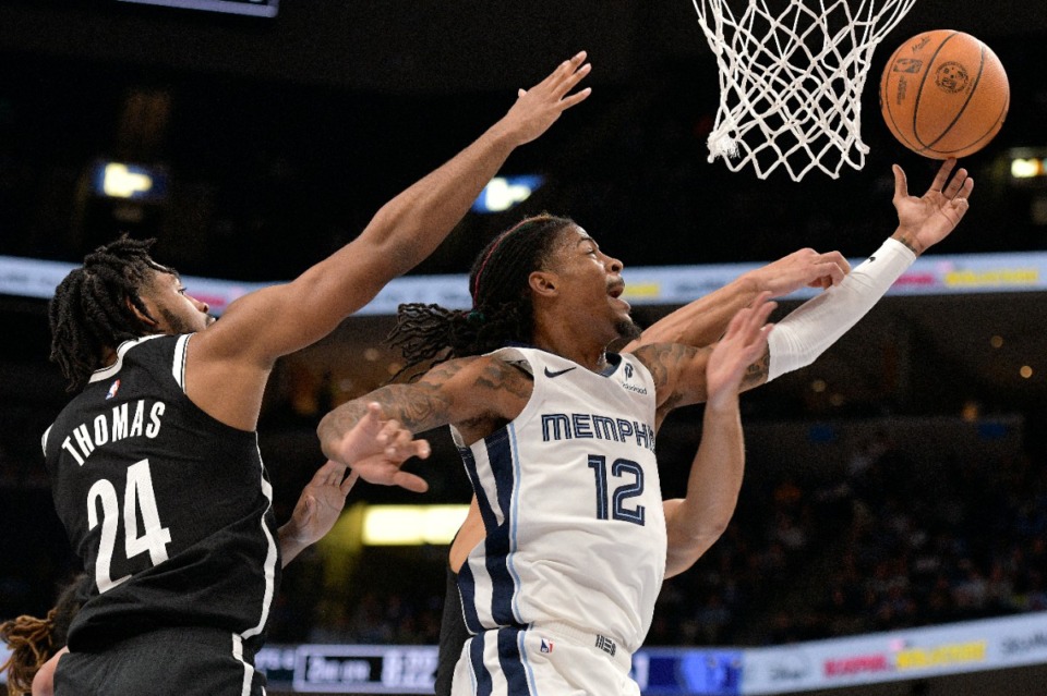 <strong>Memphis Grizzlies guard Ja Morant (12) shoots ahead of Brooklyn Nets guard Cam Thomas (24) on Wednesday, Oct. 30, 2024.</strong> (Brandon Dill/AP)