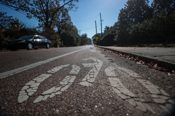 A car drives near the bike lane of McLean Boulevard Oct. 31. (Patrick Lantrip/The Daily Memphian)