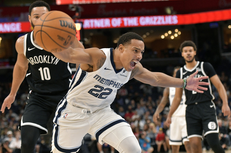 Memphis Grizzlies guard Desmond Bane (22) loses control of the ball as Brooklyn Nets guard Ben Simmons (10) looks on in the first half of an NBA basketball game Wednesday, Oct. 30, 2024, in Memphis. (Brandon Dill/AP Photo)