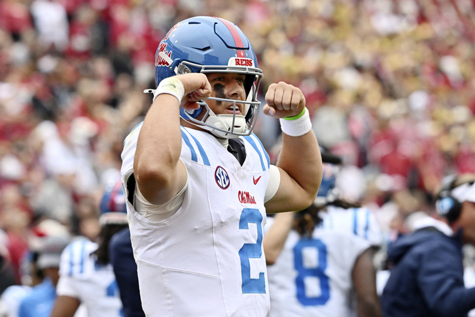 <strong>Mississippi quarterback Jaxson Dart (2) celebrates after throwing a 62-yard touchdown pass against Arkansas during the first half of an NCAA college football game Nov. 2 in Fayetteville, Ark.</strong> (Michael Woods/AP file)