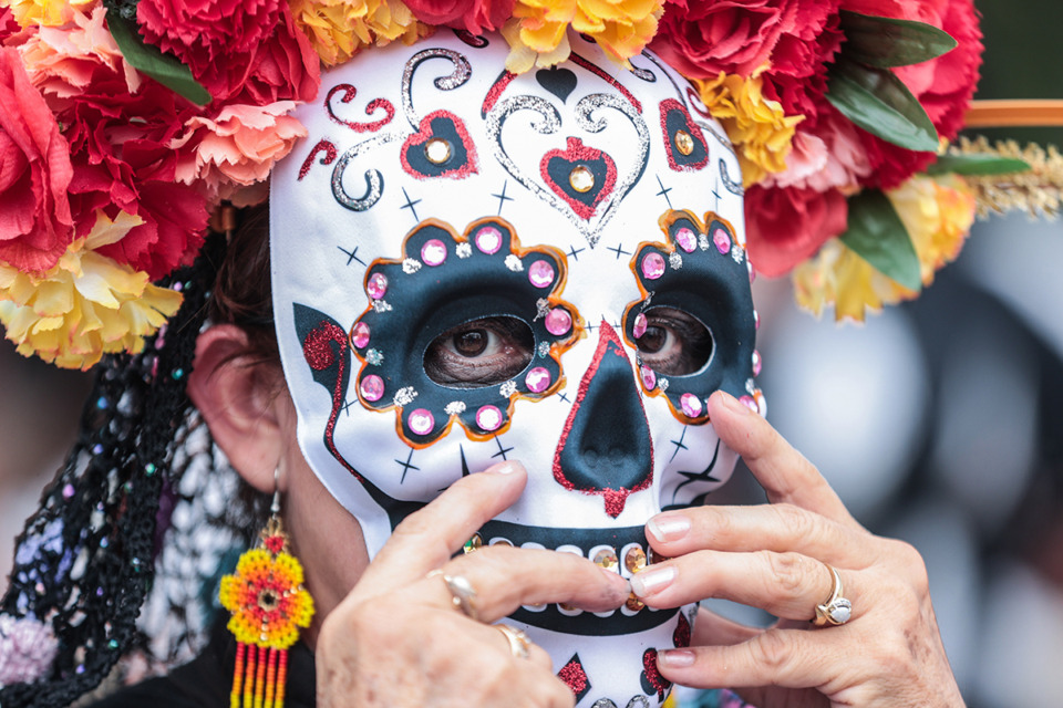 <strong>Irene Montiel puts on her mask during a Dia de los Muertes celebration at the Memphis Brooks Museum Nov. 2.</strong> (Patrick Lantrip/The Daily Memphian)