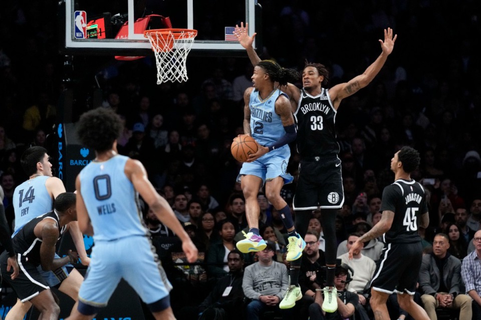 <strong>Memphis Grizzlies' Ja Morant (12) spins around Brooklyn&rsquo;s Nic Claxton (33) on Monday, Nov. 4, 2024, in New York.</strong> (Seth Wenig/AP)