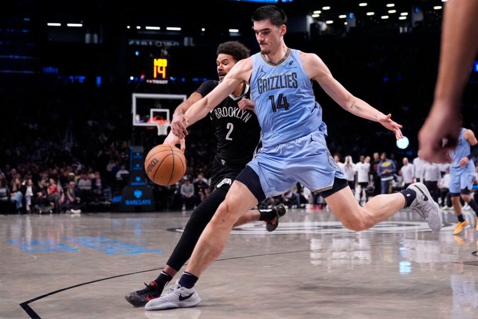 <strong>Brooklyn&rsquo;s Cameron Johnson (2), left, and Memphis Grizzlies' Zach Edey (14) chase a loose ball on Monday, Nov. 4, 2024, in New York.</strong> (Seth Wenig/AP)