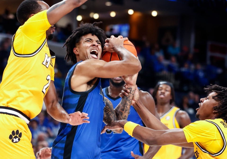 <strong>University of Memphis guard PJ Haggerty (middle) is fouled while driving the lane against the University of Missouri defense during action on Monday, Nov. 4, 2024.</strong> (Mark Weber/The Daily Memphian)