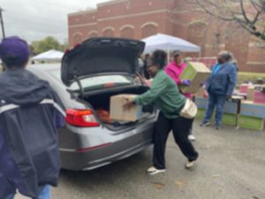 <strong>A volunteer places a box of goods into the trunk of a car at a food drive at Neighborhood Christian Centers at 785 Jackson Ave.</strong> (Julia Baker/The Daily Memphian)