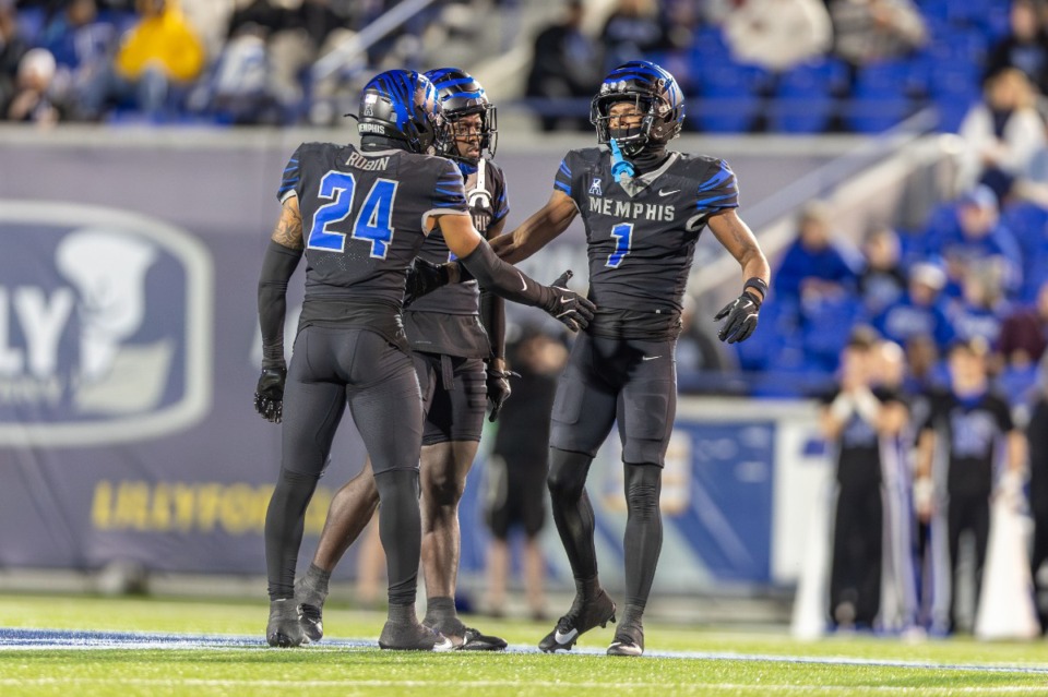 <strong>Memphis Tigers defensive backs Greg Rubin (24) and Davion Ross (1) celebrate a defensive stop against the Rice Owls on Nov. 8, 2024, at Simmons Bank Liberty Stadium.</strong> (Wes Hale/Special to The Daily Memphian)