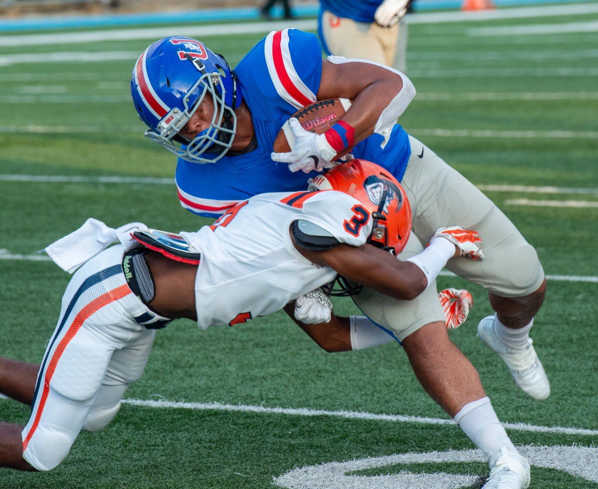 <strong>MUS running back Hunter Kendall (with ball) fights for extra yards as Ridgeway safety Nicholas Terrell tackles him on their own 20-yard line.</strong> (Greg Campbell/Special to the Daily Memphian)