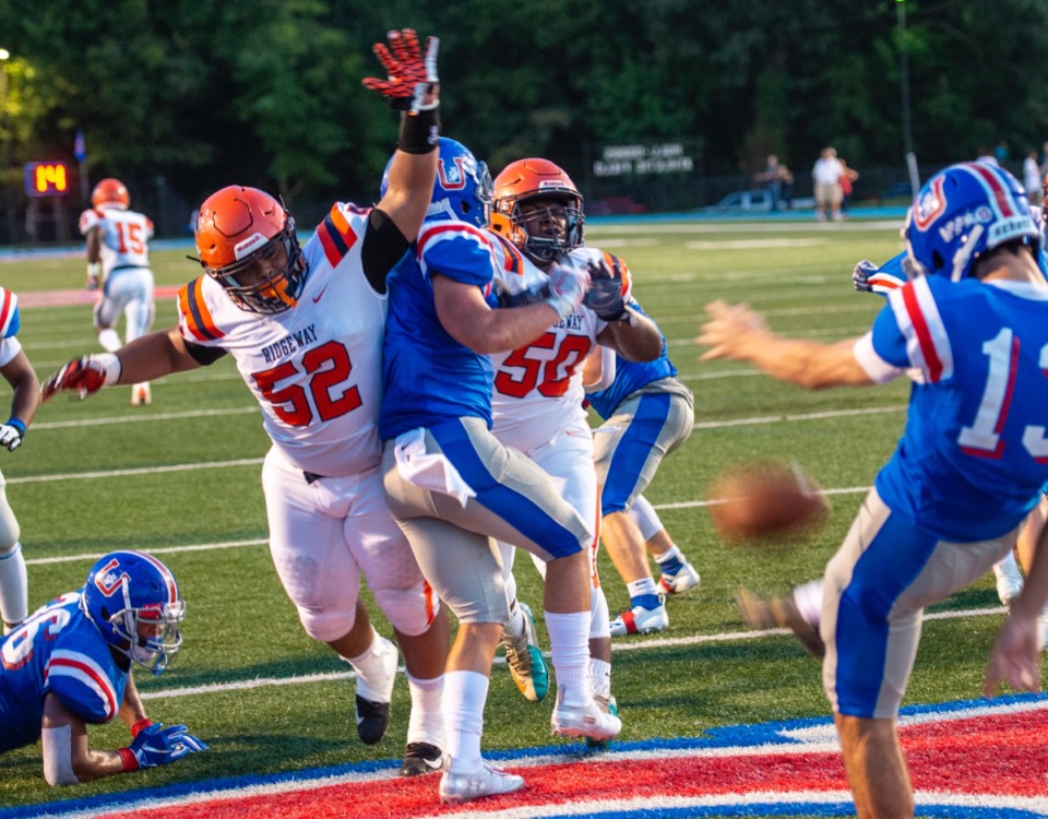 <strong>Ridgeway defensive tackles Cody Daniels (52) and Cameron Daniels (50) try to block a punt by MUS punter Ben Skahan (13) late in the second quarter during the season opener at MUS Friday night.</strong> (Greg Campbell/Special to the Daily Memphian)