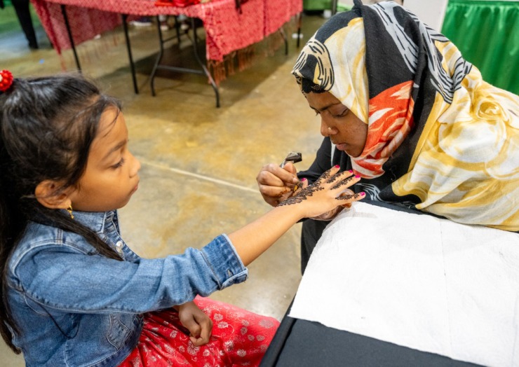 <strong>Sibara Chaluka, 8, gets a henna tattoo from Ruqsar Fatima at the IndiaFest, Saturday at the Agricenter. The India Fest saw record number of attendees despite rainy weather.</strong> (Greg Campbell/Special to The Daily Memphian)