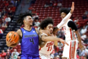 <strong>Memphis guard PJ Haggerty (4) drives against UNLV guard Brooklyn Hicks (13) during the first half of an NCAA college basketball game Saturday, Nov. 9, 2024, in Las Vegas.</strong> (Steve Marcus/Las Vegas Sun via AP)