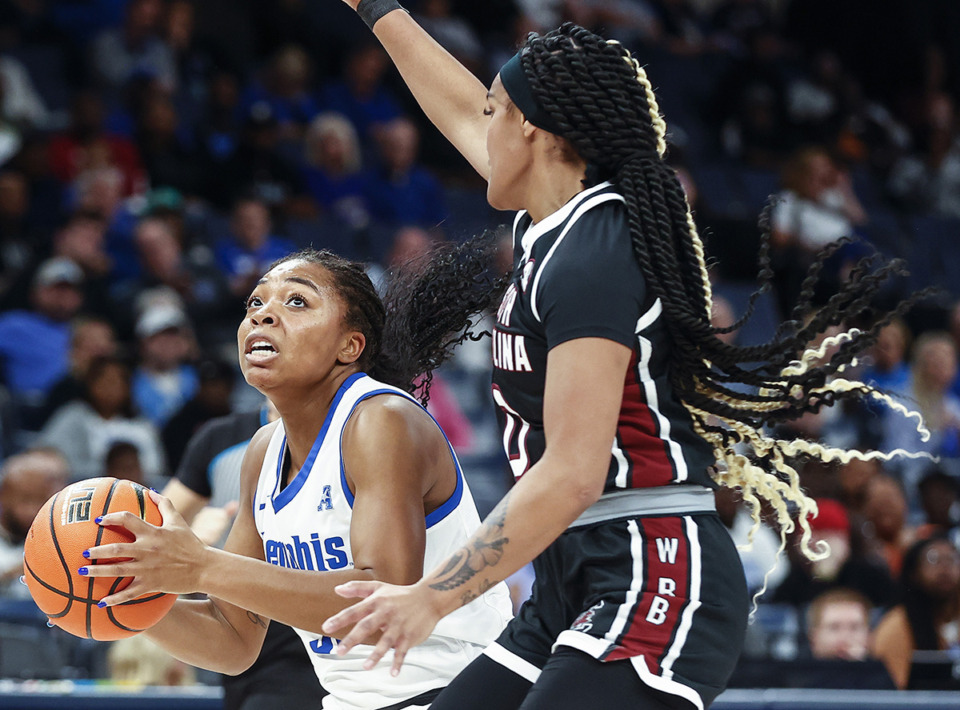 <strong>University of Memphis Tigers forward Alasia Smith had a career-high 28 points in the game against Samford on Nov. 10. Smith (left) drives to the basket against South Carolina defender Te-Hina Paopao (right) during action on Tuesday, Oct. 15, 2024.</strong> (Mark Weber/The Daily Memphian file)