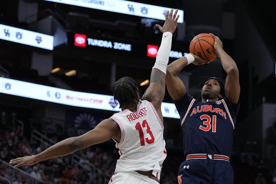 <strong>Auburn forward Chaney Johnson (31) scores over Houston forward J'Wan Roberts (13) during the first half of an NCAA college basketball game Saturday, Nov. 9, 2024, in Houston.</strong> (Kevin M. Cox/AP Photo)