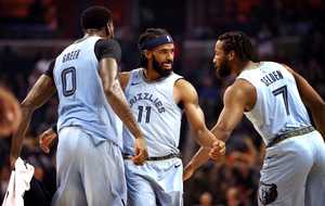 <p class="p1"><strong>Mike Conley (center), forward for the Memphis Grizzlies, high fives players after scoring a basket during the Friday, Oct. 19, 2018, season opener against the Atlanta Hawks at FedExForum in Memphis.</strong> (Houston Cofield/Daily Memphian)