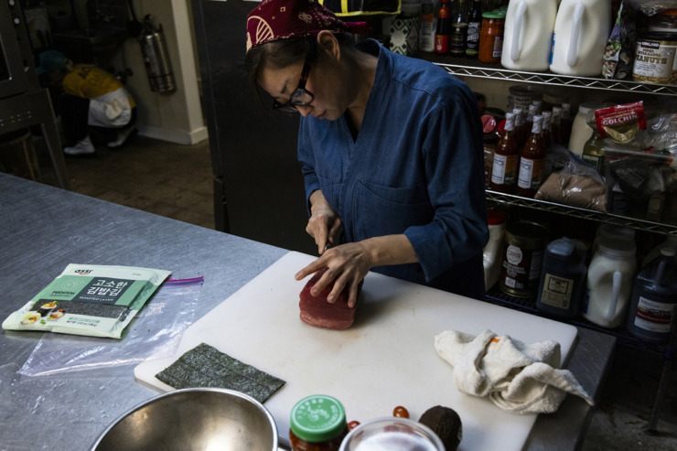 Sushi chef Mindy Sun works to create a sushi roll that will be featured in Karen Carrier&rsquo;s pop-up of her much-missed Do Sushi restaurant inside Bar DKDC. (Brad Vest/Special to The Daily Memphian)