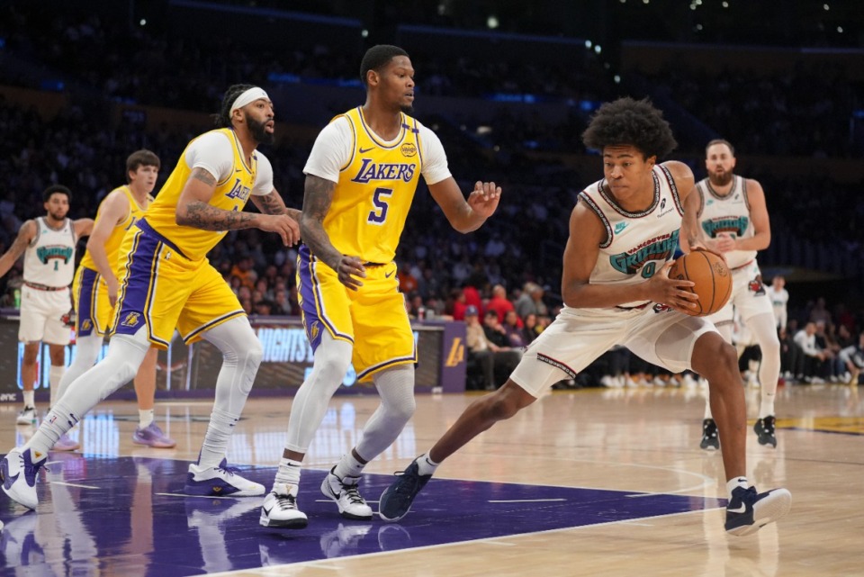 <strong>Memphis Grizzlies forward Jaylen Wells (0) looks to charge past Los Angeles Lakers forward Cam Reddish (5) on Wednesday, Nov. 13, 2024, in Los Angeles.</strong> (Marcio Jose Sanchez/AP)