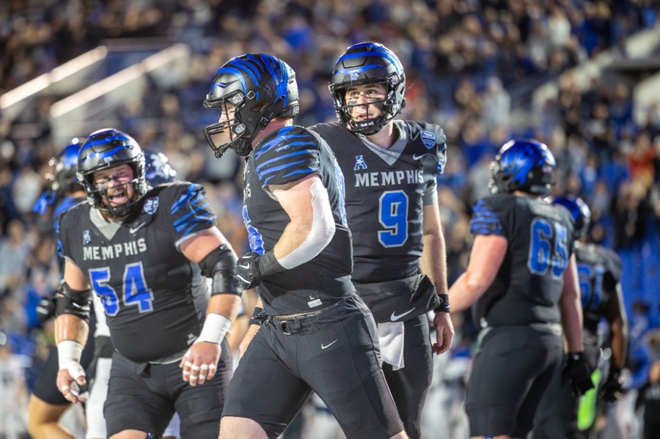 <strong>Memphis Tiger quarterback Seth Henigan (9) throws a touchdown pass to Brendan Doyle (86) during the second quarter against the Rice Owls on Nov 08, 2024 at Simmons Bank Liberty Stadium.</strong> (Wes Hale/Special for The Daily Memphian)