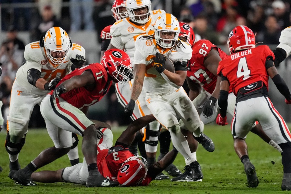 <strong>Tennessee running back Peyton Lewis (27) tries to brel free from Georgia's CJ Allen (3) and Jalon Walker (11) during the first half of an NCAA college football game, Saturday, Nov. 16, 2024, in Athens, Ga.</strong> (John Bazemore/AP)