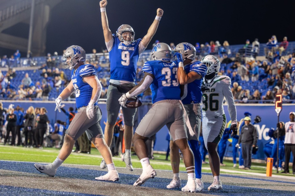 <strong>Memphis quarterback Seth Henigan (9) celebrates after a touchdown pass to Tigers tight end Jamauri Chislom (33) in a win over UAB on Saturday night.</strong> (Wes Hale/Special to the Daily Memphian)