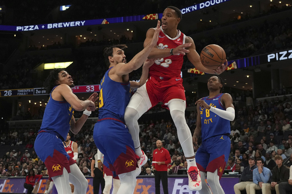 <strong>Memphis Grizzlies guard Desmond Bane (22) tries to pass the ball away from Denver Nuggets defenders Julian Strawther, Dario Saric and Peyton Watson (8) in the first half of an NBA basketball game, Sunday, Nov. 17, 2024, in Memphis.</strong> (Mark Humphrey/AP Photo)