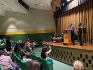 <strong>Memphis Mayor Paul Young, at podium, and Memphis Police Department Interim Chief C.J. Davis, right, address community members at the latest stop of the One Memphis Tour at Booker T. Washington High School. The last of the year, this One Memphis meeting centered around road infrastructure improvements, blight and crime.</strong> (Julia Baker/The Daily Memphian)