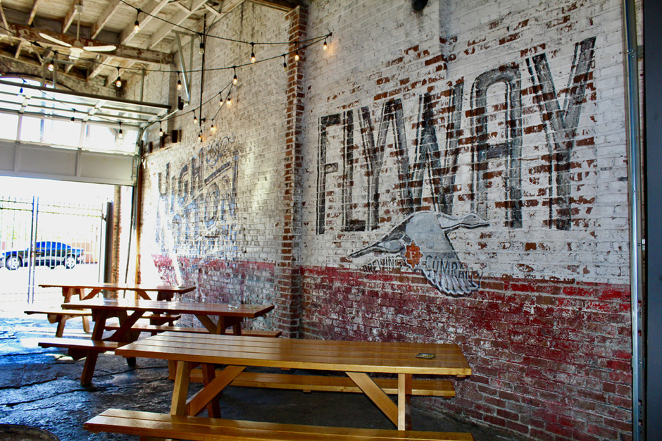 <strong>Flyway Brewing Co. joined High Cotton Co. with a mural along the white rustic brick wall.</strong> (Sophia Surrett/The Daily Memphian)