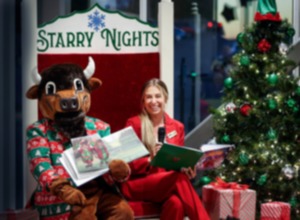 <strong>Beale the Buffalo show the book illustrations as Courtney Blackburn reads "Park Pals &amp; The Grand Opening of Starry Nights" to those gathered on Wednesday, Nov. 20, 2024 at Shelby Farms.</strong> (Mark Weber/The Daily Memphian)