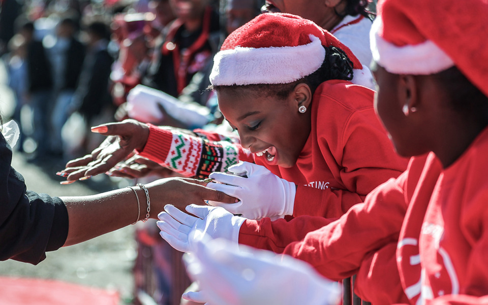 <strong>Local kids get handfuls of candy while at the Memphis Christmas Parade in Whitehaven on Nov. 23.</strong> (Patrick Lantrip/The Daily Memphian)