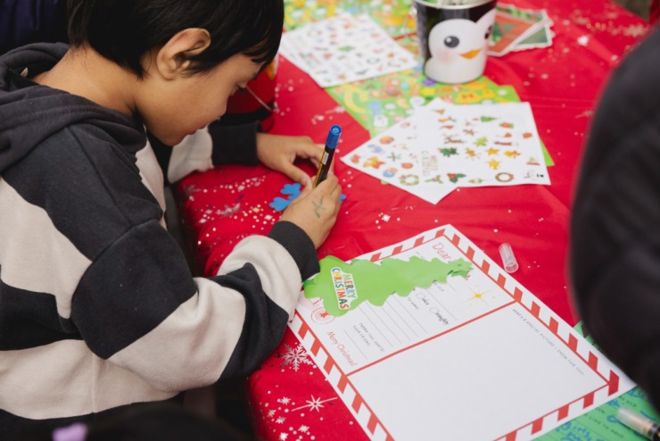 <strong>Ryan Nagy writes letters to Santa during the Saturday, Nov. 23, 2024 Downtown Holiday Tree Lighting sponsored by the Downtown Memphis Commission.</strong> (Ziggy Mack/Special to The Daily Memphian)