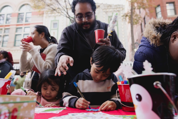 <strong>Siblings Amara (left) and Ryan write letters to Santa Claus with help from their dad, Mohamad Nagy during the Saturday, Nov. 23, 2024 Downtown Holiday Tree Lighting sponsored by the Downtown Memphis Commission.</strong> (Ziggy Mack/Special to The Daily Memphian)