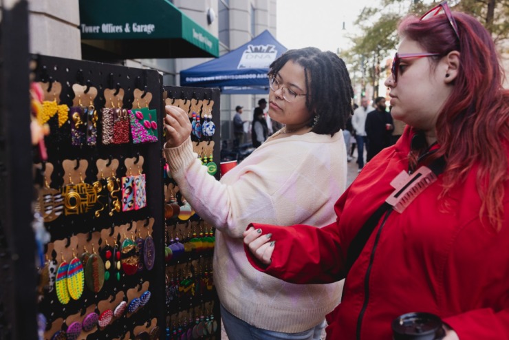 <strong>Cait Mocan (right) and Maya Morris shop wares from vendors on Main Street during the Saturday, Nov. 23, 2024 Downtown Holiday Tree Lighting sponsored by the Downtown Memphis Commission.</strong> (Ziggy Mack/Special to The Daily Memphian)