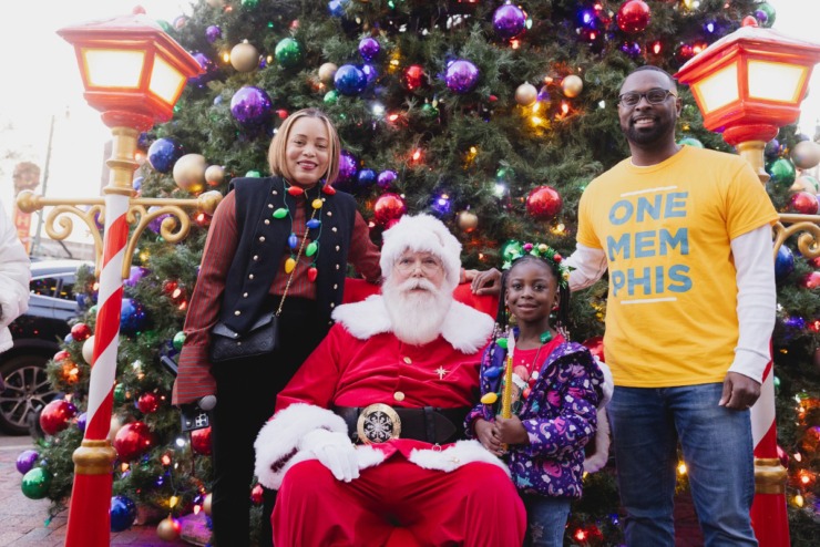 <strong>Downtown Memphis Commission President Chandell Ryan (left) and Mayor Paul Young (right), visit Santa and a young friend during the Saturday, Nov. 23, 2024 Downtown Holiday Tree Lighting sponsored by the Downtown Memphis Commission.</strong> (Ziggy Mack/Special to The Daily Memphian)