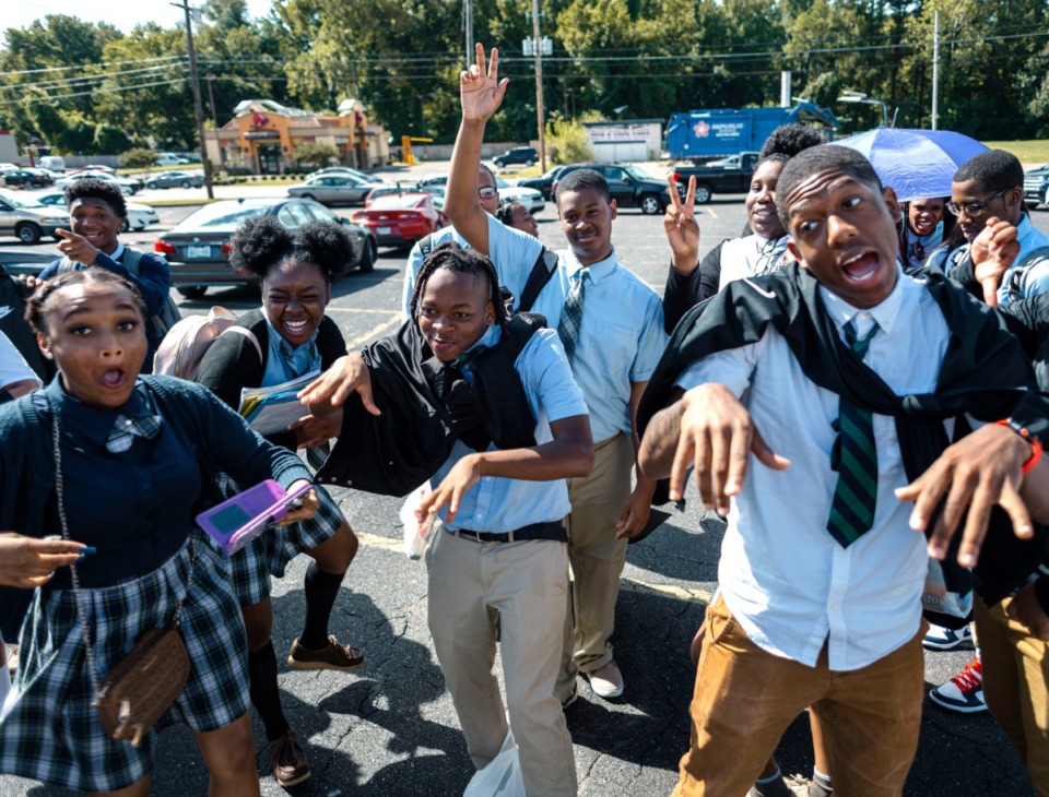 <strong>Kamron Barnes (center), a senior at Memphis Business Academy, joins his classmates Brianna Richardson (left) and Wade Rodgers Jr. (right) as they celebrate the announcement that the school will begin major renovations in Harmony Plaza to convert retail space into an updated STEM facility.</strong> <strong>Memphis STEM (Science, Technology, Engineering and Mathematics) Academy will anchor the development at 2200 Frayser Blvd.</strong> (Houston Cofield/Special to the Daily Memphian)