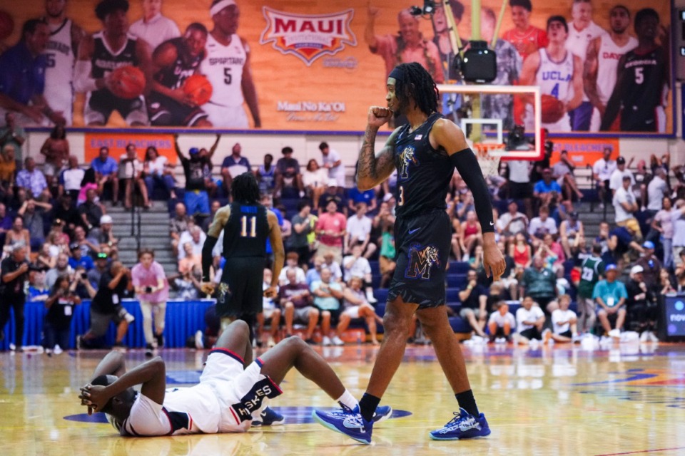 <strong>Memphis guard Colby Rogers, right, celebrates a 99-97 win in overtime as UConn guard Hassan Diarra, left, lies on the ground at the Maui Invitational Monday, Nov. 25, 2024, in Lahaina, Hawaii.</strong> (Lindsey Wasson/AP)