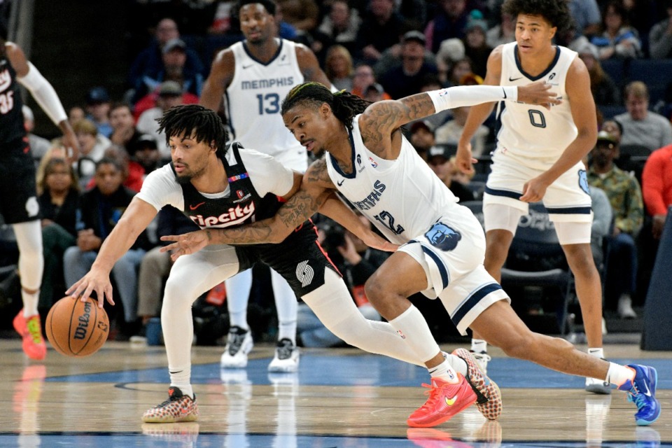 <strong>Memphis Grizzlies point guard Ja Morant goes for a steal against Portland Trail Blazers guard Shaedon Sharpe, left, Monday, Nov. 25, 2024.</strong> (Brandon Dill/AP)