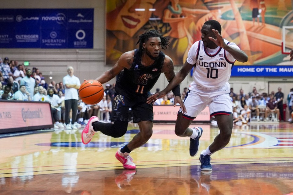 <strong>Memphis guard Tyrese Hunter (11) moves the ball against UConn guard Hassan Diarra (10) during the second half of an NCAA college basketball game at the Maui Invitational Monday, Nov. 25, 2024, in Lahaina, Hawaii. Memphis won 99-97 in overtime.</strong> (AP Photo/Lindsey Wasson)