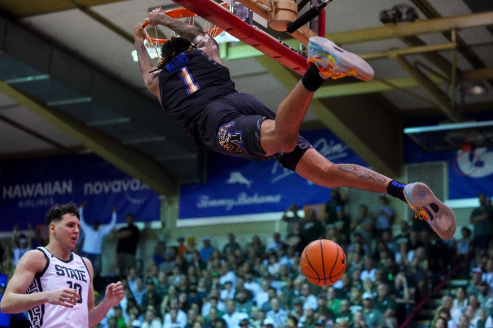 <strong>Memphis guard Jared Harris dunks against Michigan State center Szymon Zapala at the Maui Invitational on Tuesday, Nov. 26, in Lahaina, Hawaii.</strong> (Lindsey Wasson/AP file)