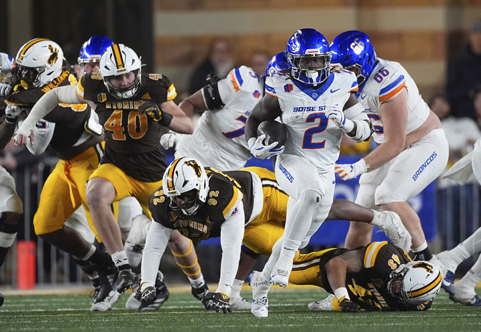 <strong>Boise State running back Ashton Jeanty (2) runs past Wyoming defensive end Tyce Westland (40), defensive tackle Dante Drake (92) and linebacker Shae Suiaunoa (43) in the first half of an NCAA college football game Saturday, Nov. 23, 2024, in Laramie, Wyo.</strong> (David Zalubowski/AP Photo)